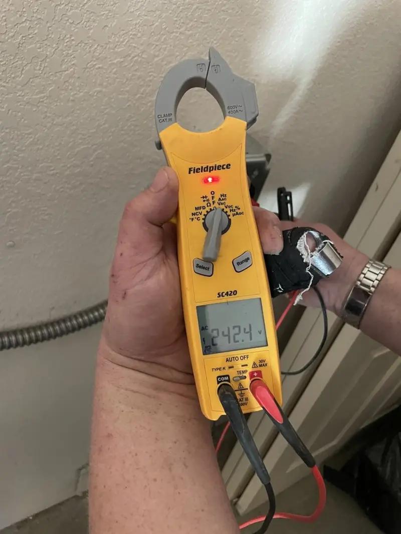 Voltage testing with clamp meter during Outlet Installation in Los Ranchos de Albuquerque
